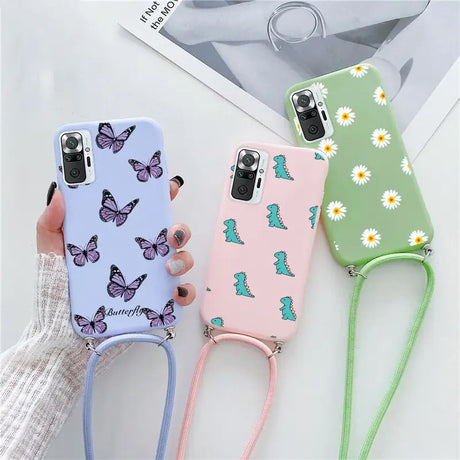 a woman holding a phone case with butterflies on it