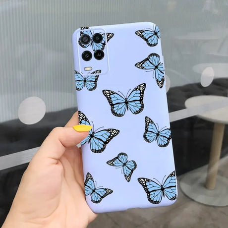 a woman holding a phone case with butterflies on it