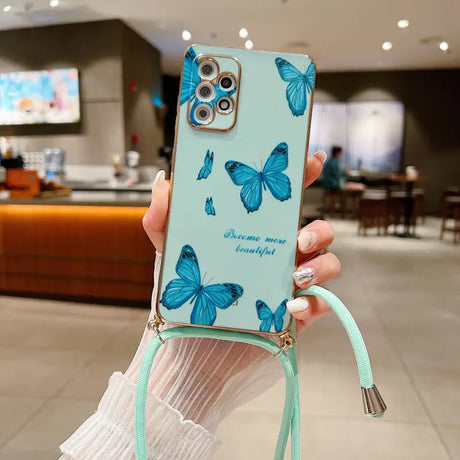 a woman holding a phone case with blue butterflies on it