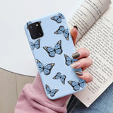 a woman holding a book and a blue butterfly phone case