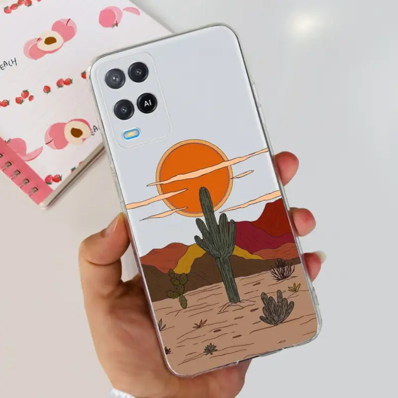 a hand holding a phone case with a desert scene