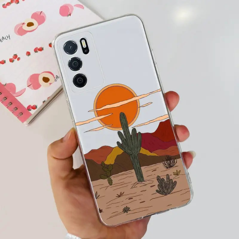 a person holding a phone case with a desert scene