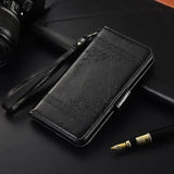 a black leather wallet case with a pen and camera