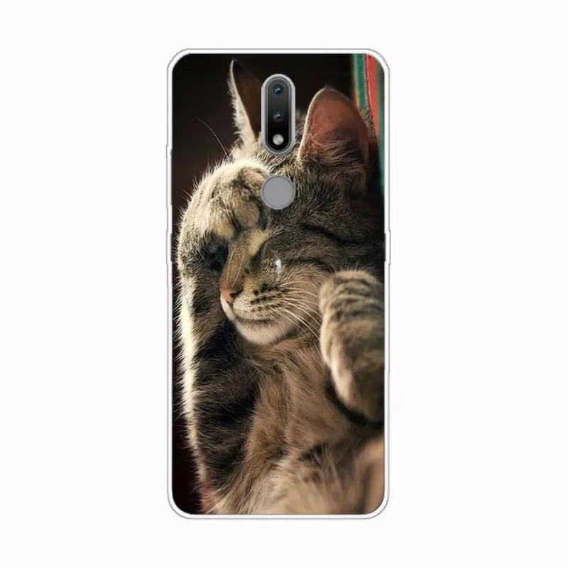 a cat is looking at the camera on a phone case