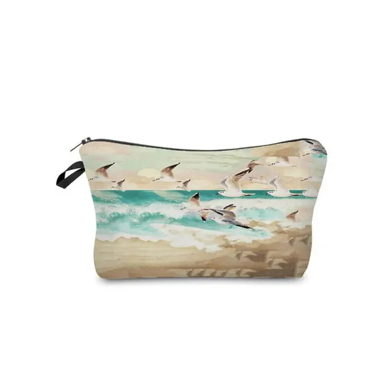 a small cosmetic bag with a painting of birds flying over the ocean