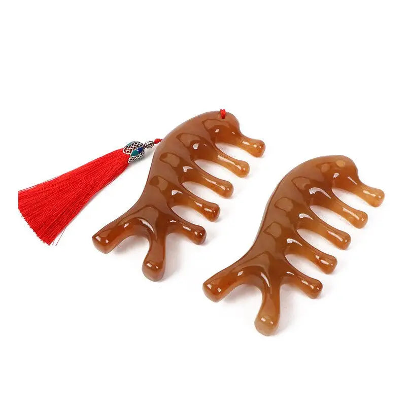 pair of brown hair clips with tassels on white background