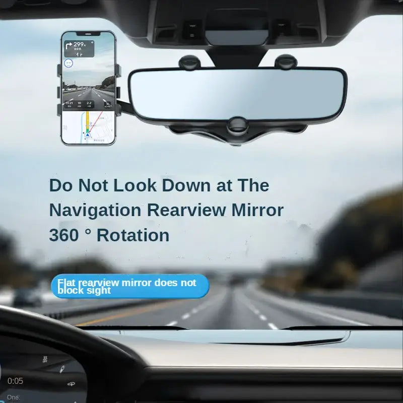 A car dashboard with a view of the road and a phone