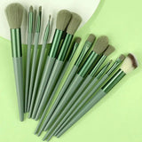 a set of makeup brushes on a green background