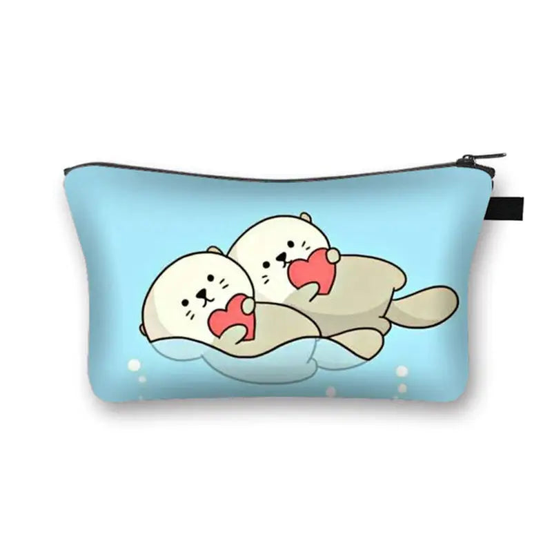 a blue and white pouch bag with two sea otters