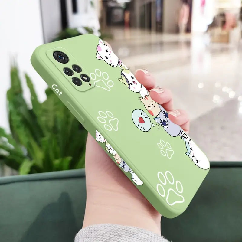 a person holding a green phone case with a cartoon character design