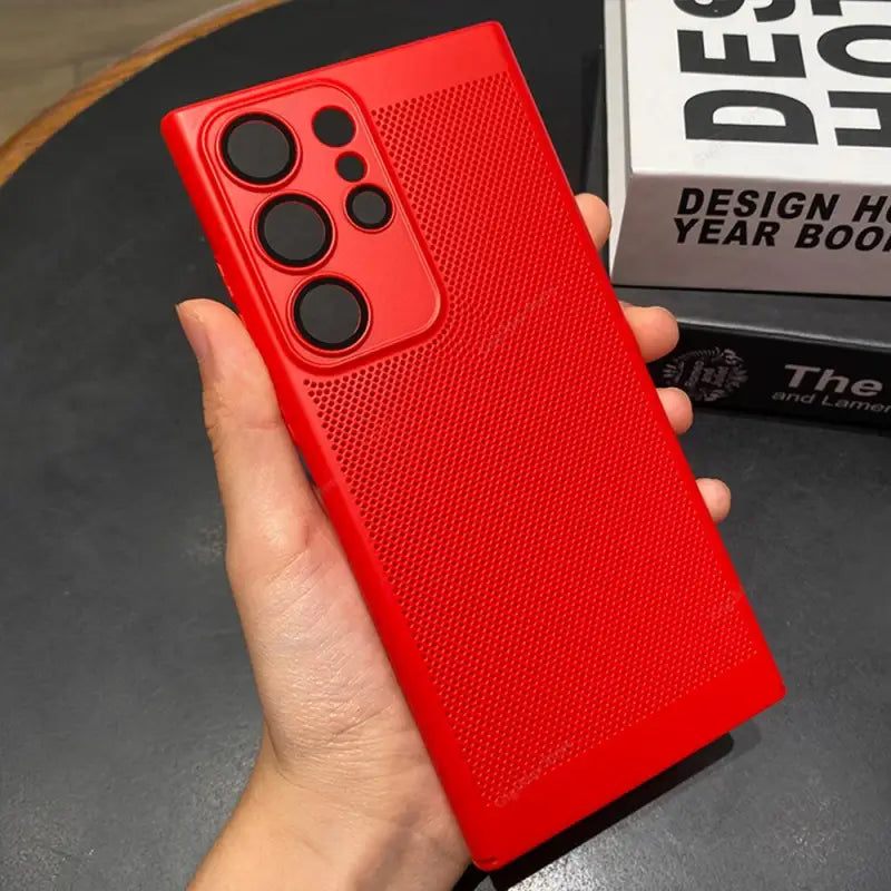 the red case is held up in a hand