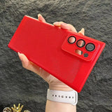 a hand holding a red case with a pair of glasses