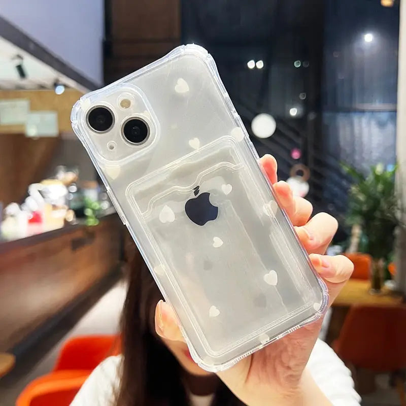 a woman holding up a clear case for an iphone