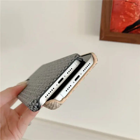 The case is made from a grey fabric and has a white interior