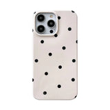 the back of a white iphone case with black polka dots