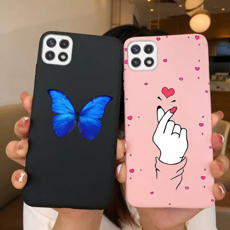 a woman holding a phone case with a butterfly on it