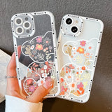 a woman holding a phone case with a floral design