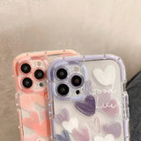 two iphone cases with hearts on them