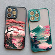 two cases with a pink and green landscape