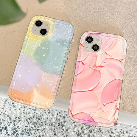 two cases with a pink and blue marble pattern