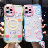 two people holding up their phone cases with smiley faces