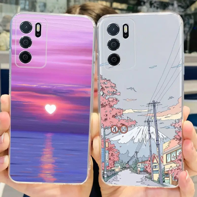 two cases with a sunset scene on them
