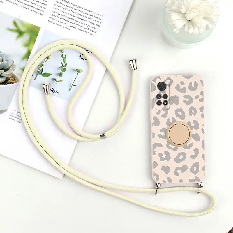 a phone case with a white strap and a pink leopard print