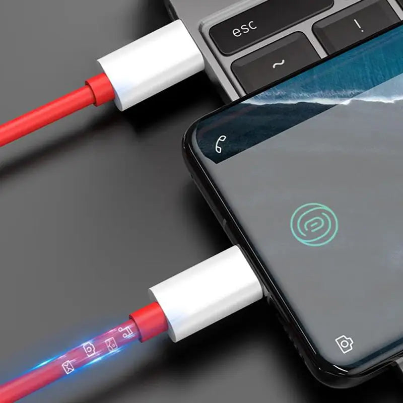 there is a cell phone connected to a charging cable with a red cord