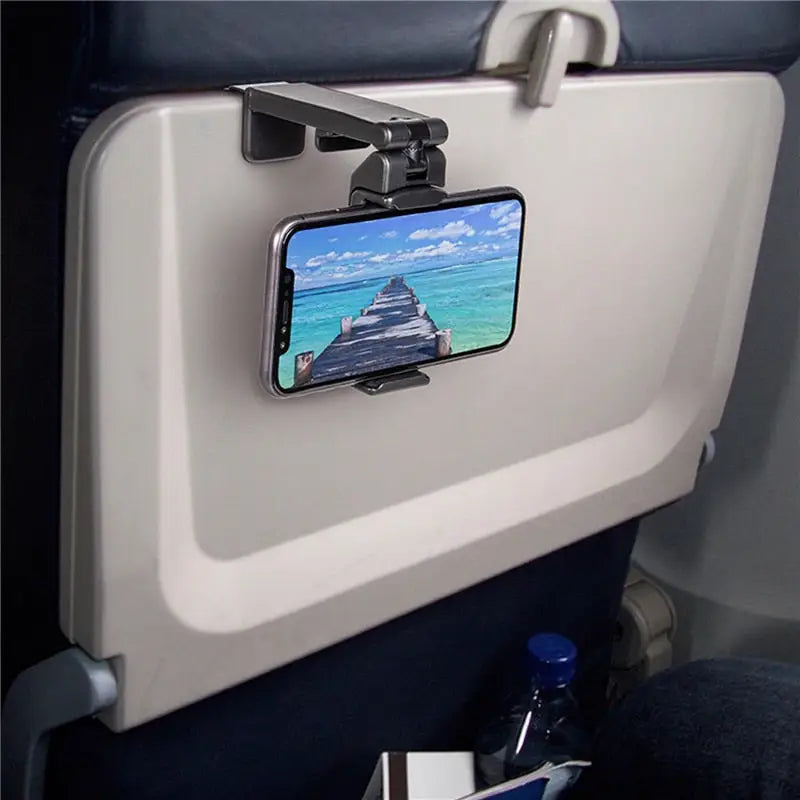 a cell phone holder on the seat of an airplane