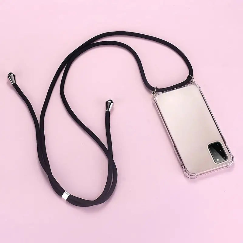 a cell phone with a black strap on a pink background