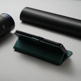 A cell phone and a pen on a table