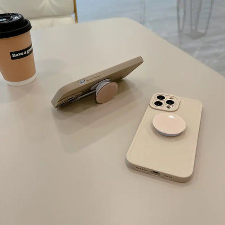 a cup of coffee and a cell phone on a table