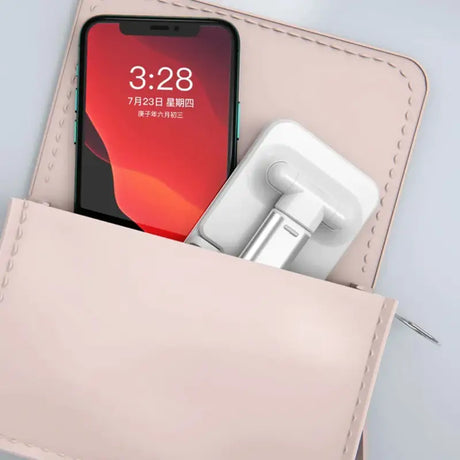 There is a cell phone in a wallet with a charger