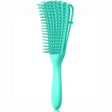 a close up of a green hair brush with a handle