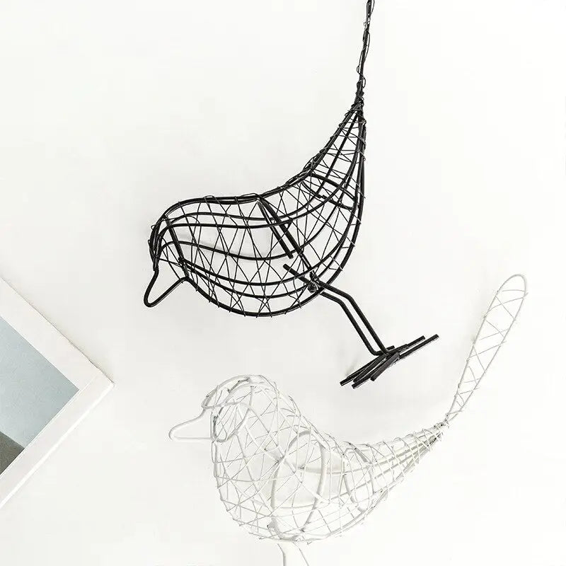 a metal bird sculpture next to a book