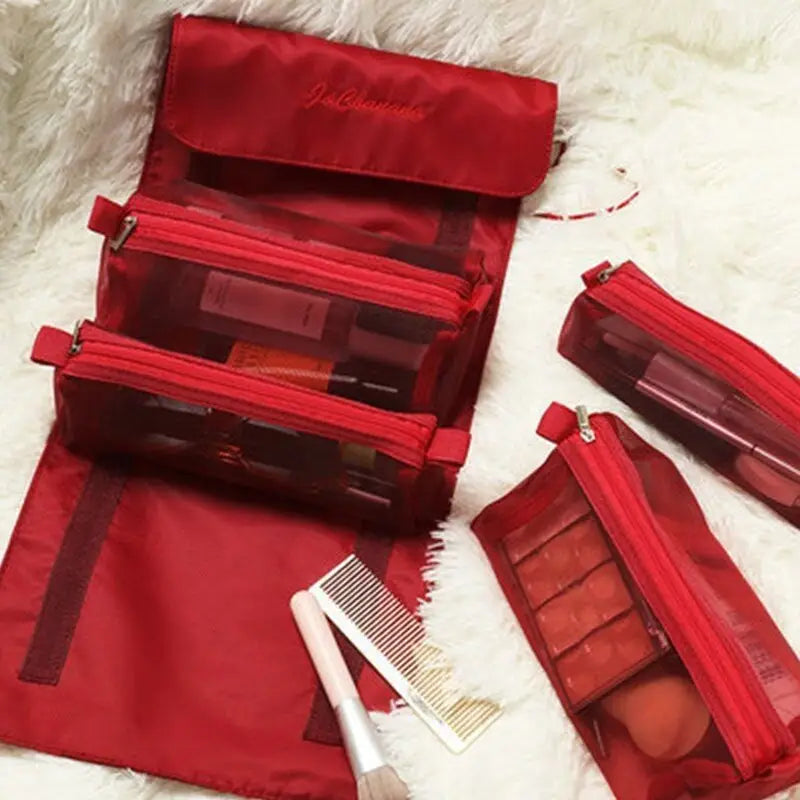 there are three red bags with makeup and brushes on a white fur