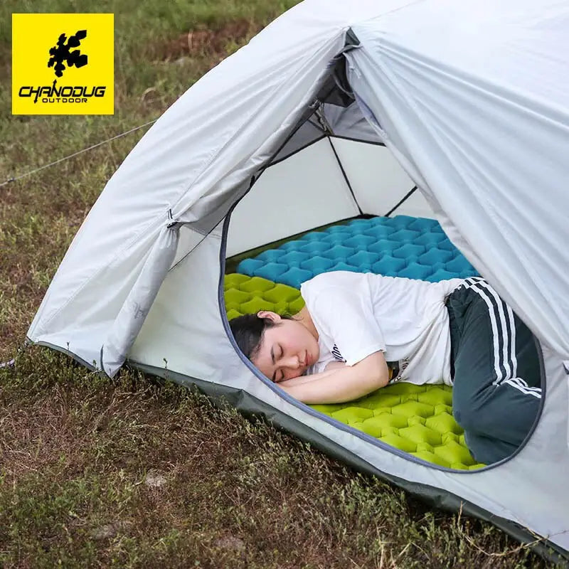 a man sleeping inside a tent