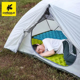 a man sleeping inside a tent