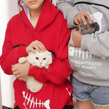 two children holding a cat in their hands