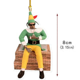 a christmas orname with a man sitting on a brick