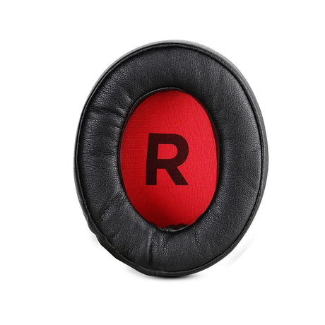 Circular black ear cushion with a red center displaying the letter ’R’.