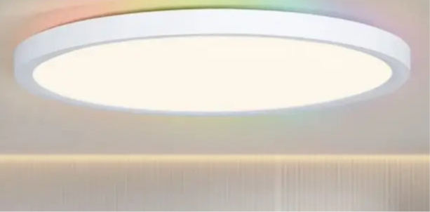 Circular LED ceiling light fixture emitting warm white illumination.