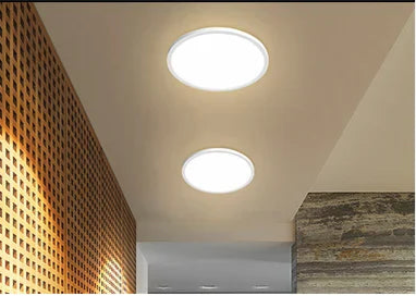 Circular ceiling lights illuminating an interior space.