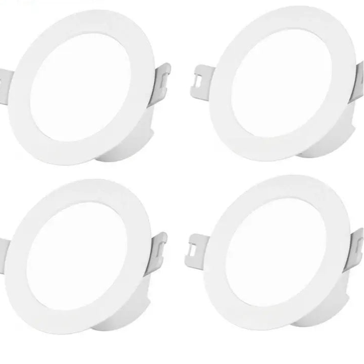 Circular white recessed light fixtures with mounting brackets.