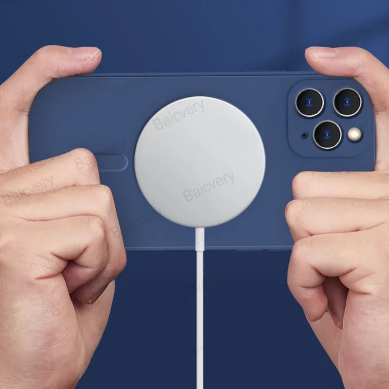 Circular white wireless charging pad attached to a blue smartphone.