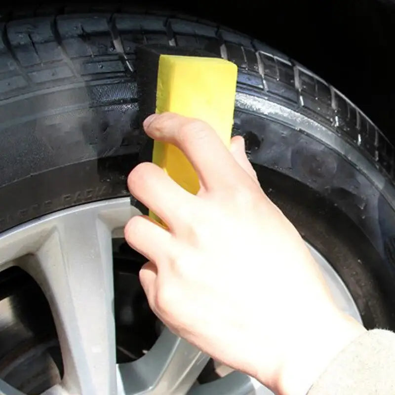 someone removing a tire with a sponge