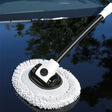 a car windshield brush with a white handle