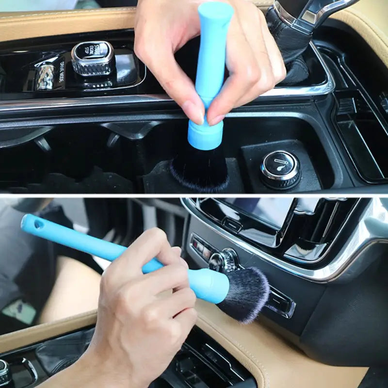 a person cleaning a car dashboard with a brush