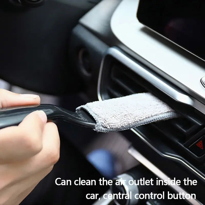 a person cleaning a car with a cloth