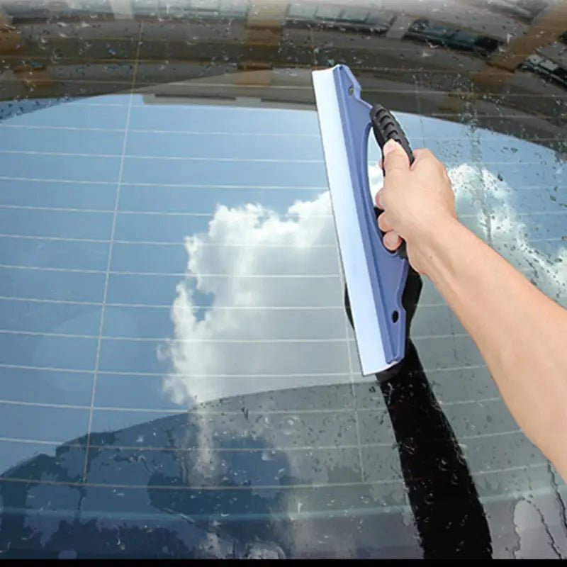 a person cleaning a car with a sponge